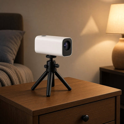 FlexGrip Mini Tripod Stand holding a mini portable projector on a bedside table