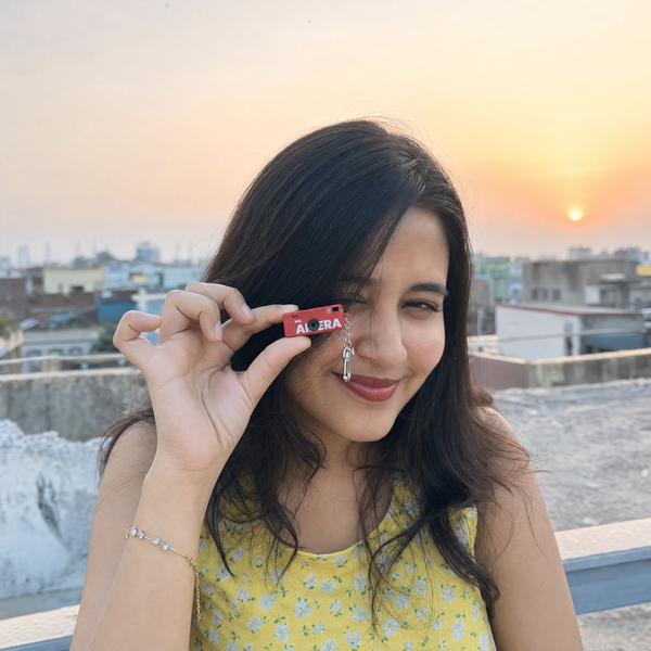 Rooftop sunset portrait holding the red Retro84 mini camera