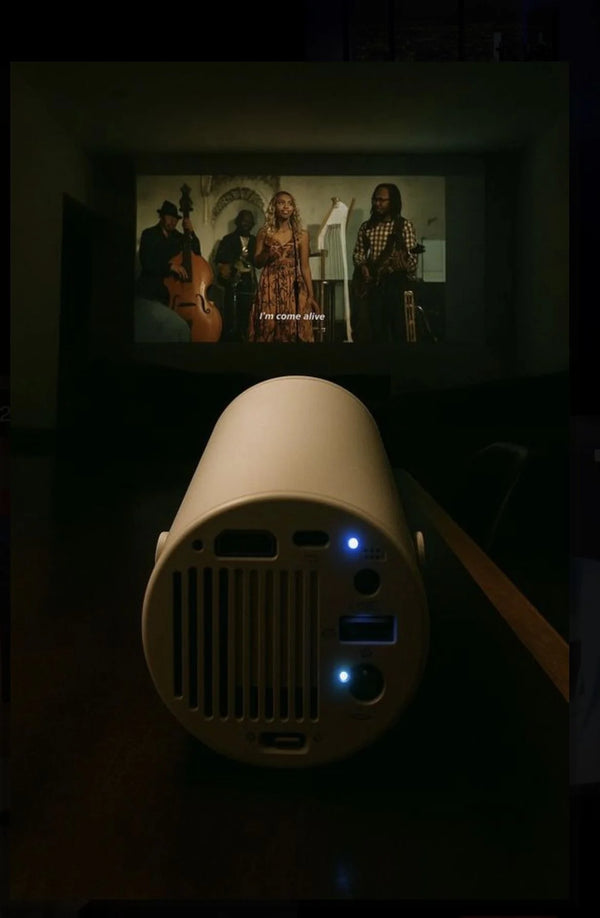 Movie playing on the wall in a dark room